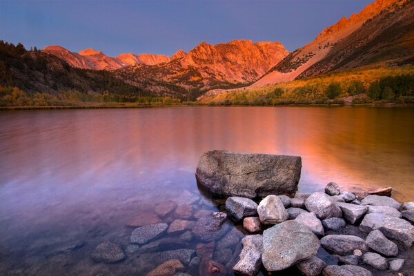 A clear lake among the mountains at sunset