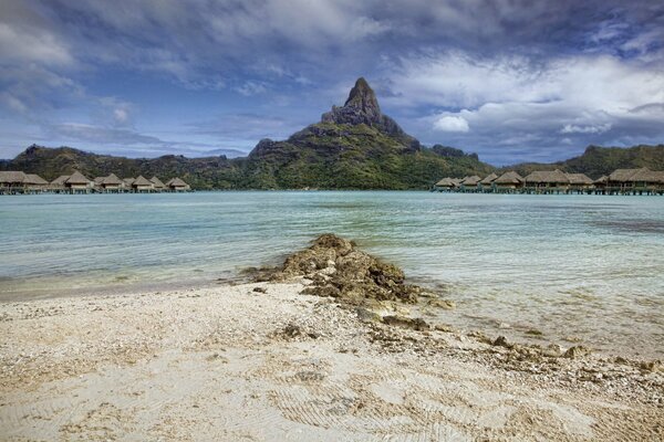 Sandy beach near straw huts