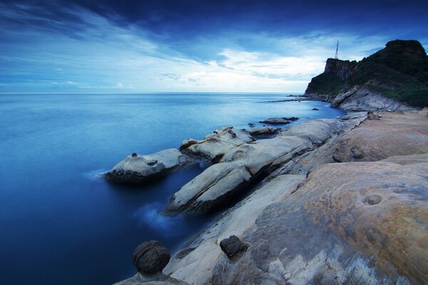 A lonely man is sitting by the sea