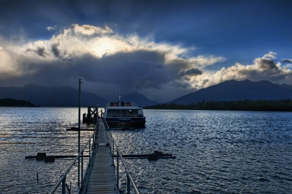 Landscape of the water surface. The boat is at the raft. Reflection of the sky in the water