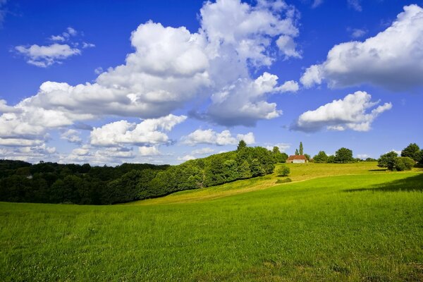 A house on a beautiful field and a beautiful sky