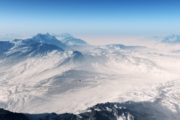 Bird s-eye view of snow-capped mountains