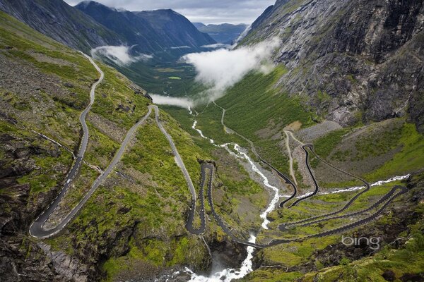 Landscape of a mountain serpentine. A long river flows between the mountains