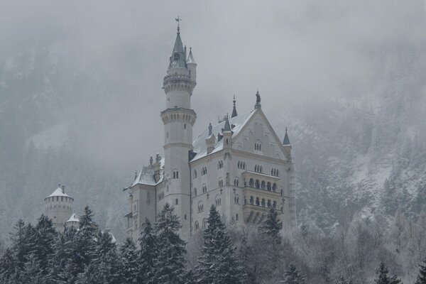 An ice castle shrouded in snowy mountains