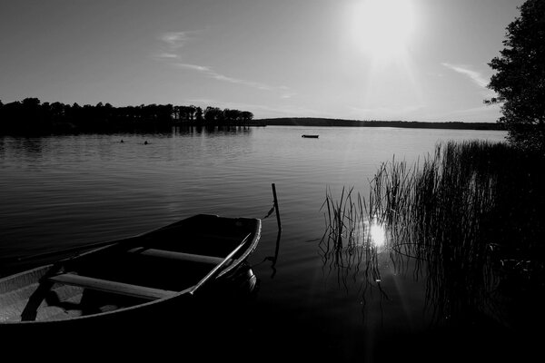 Abandoned boat at night on the lake