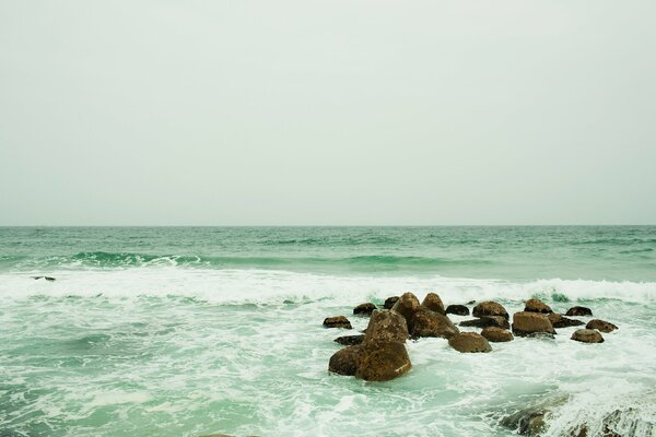 Waves crashing on rocks bring a lot of splashes