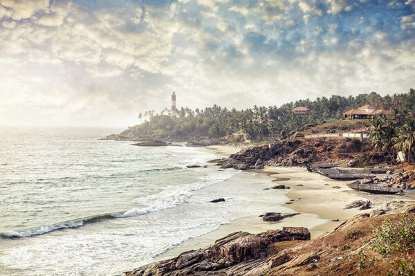 Sea surf with a lighthouse visible in the distance