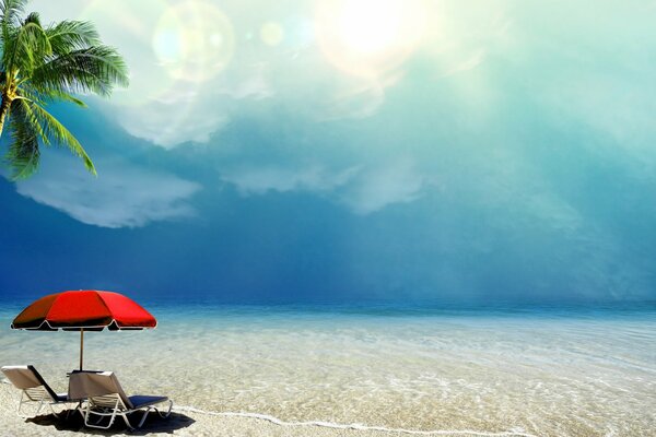 Umbrella, sun beds on the white ocean shore