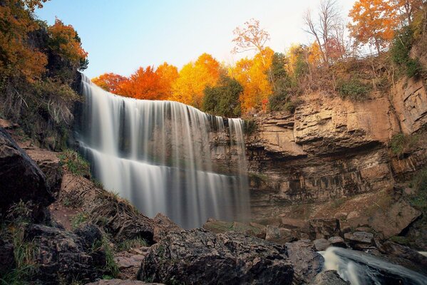 Waterfall among the rocks in autumn