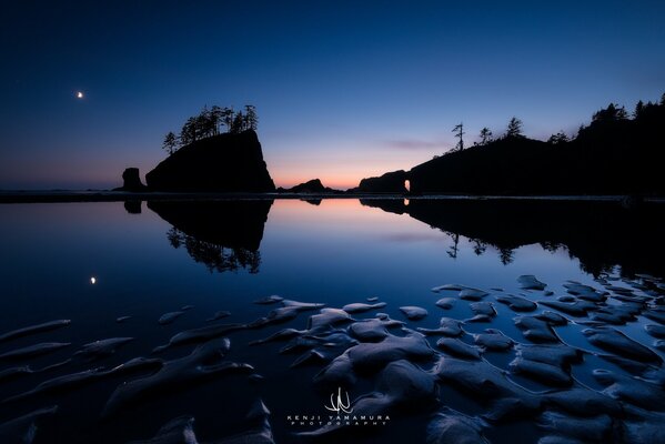 A bright star over a night lake