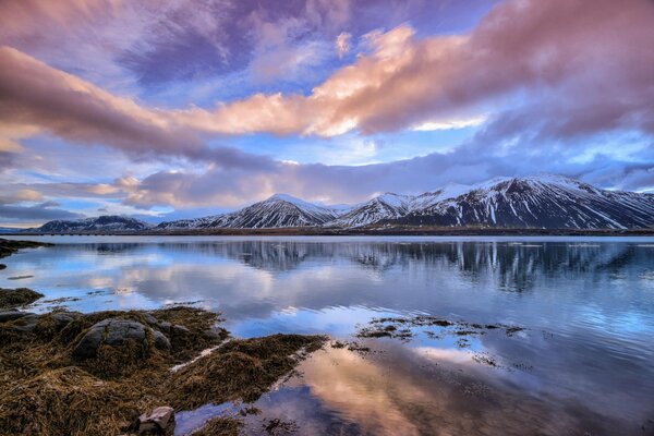 Luxurious clouds over the surface of the lake in winter