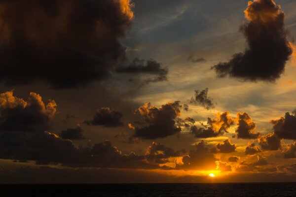 Clouds on the background of the setting sun