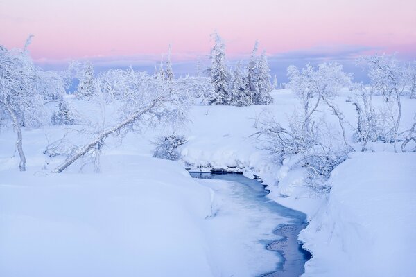 A small river through ice and snow