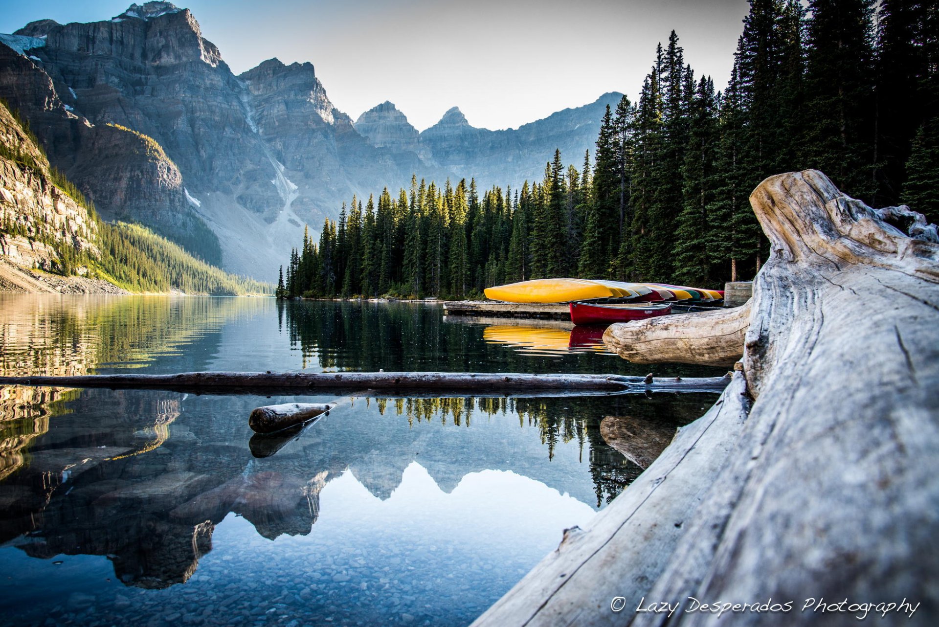 mountain tops snow forest lake canoes canada