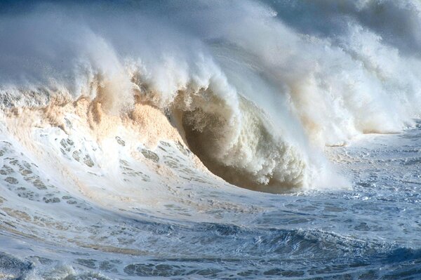 The crest of the wave and the white foam of the ocean