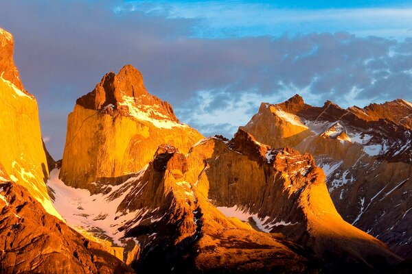 Panorama of sharp mountains illuminated by the setting sun