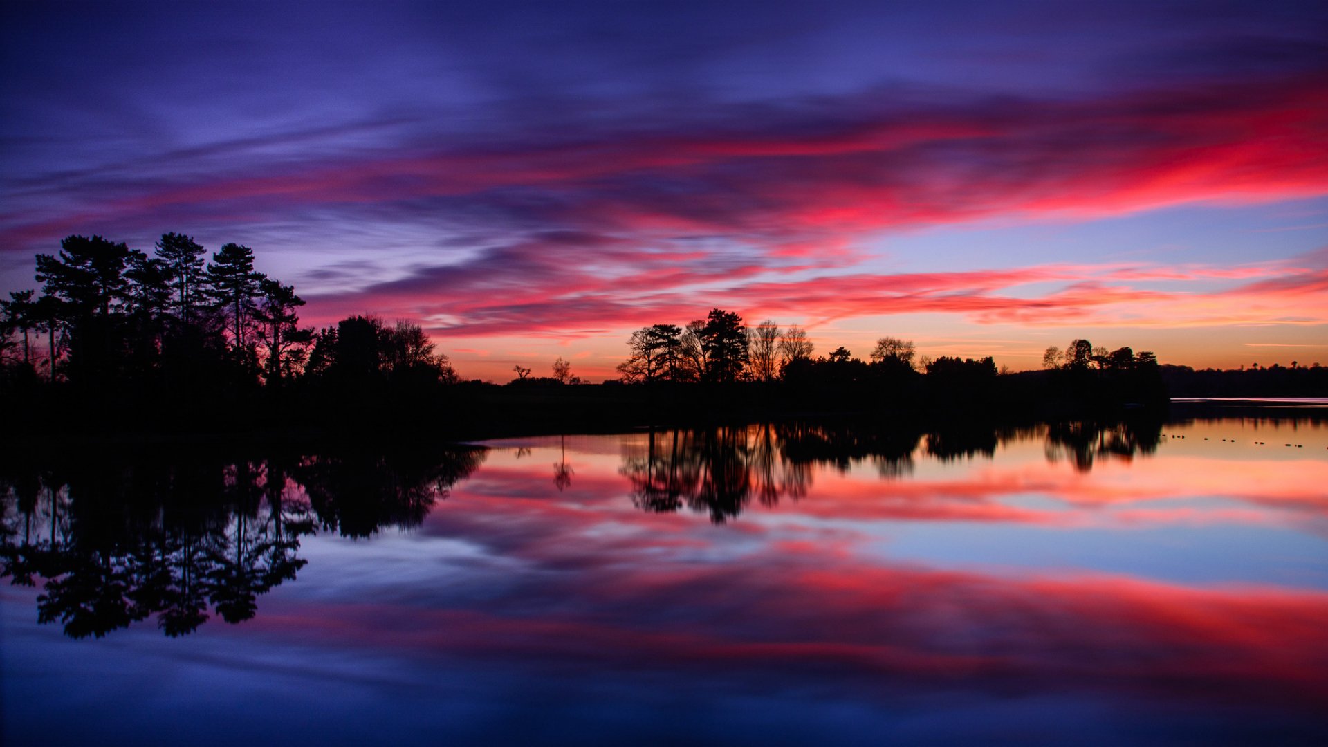 united kingdom england reservoir water surface of beach forest tree night sunset sky clouds reflection