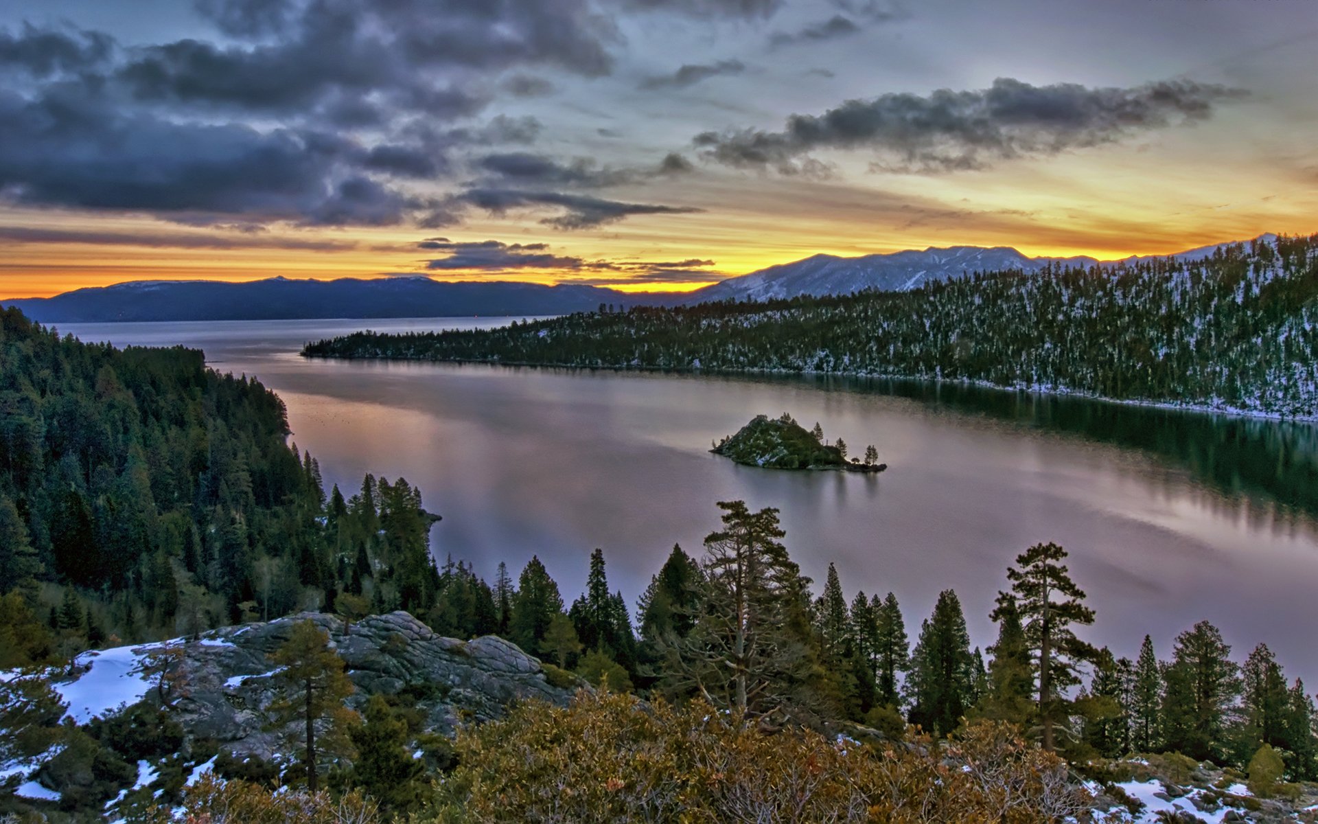 river rock tree conifers forest snow clouds sunset