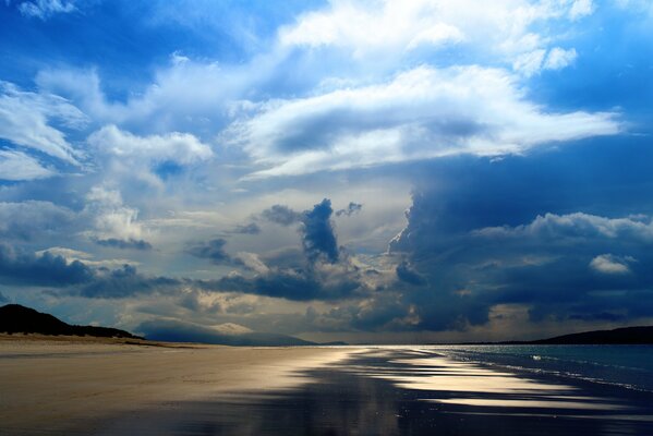 The seashore under blue clouds