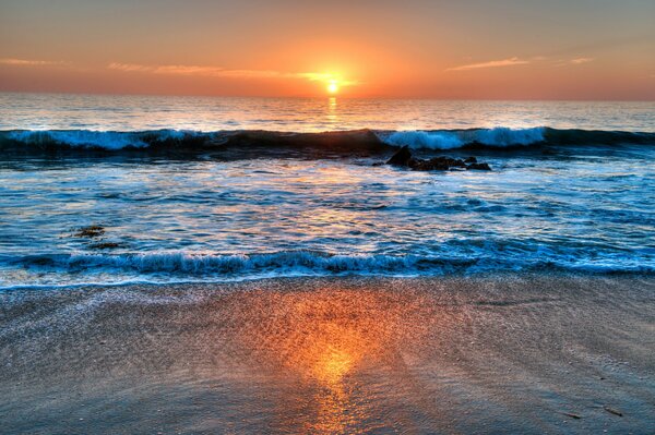 Sunset and waves beating on the shore