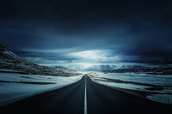 Endless winter road at night