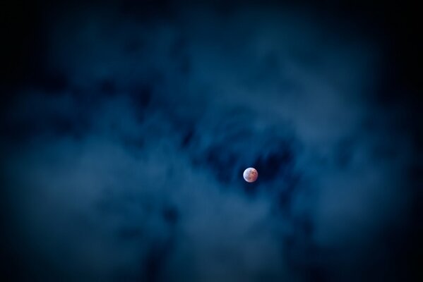 Full moon on the background of a blue sky with a haze