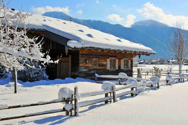 A sunny winter day and a house in the mountains