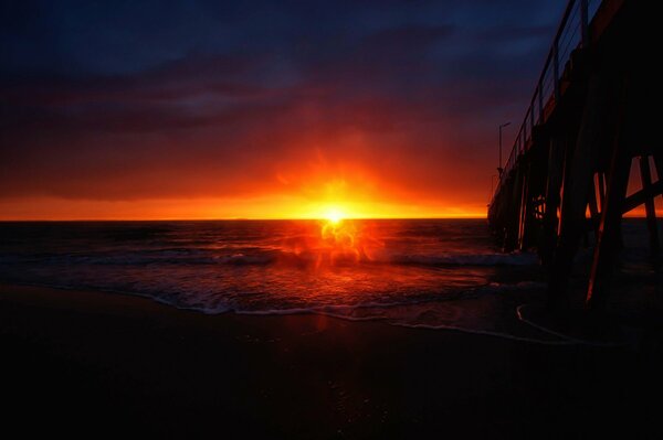 A bright purple sunset that can be seen from the pier