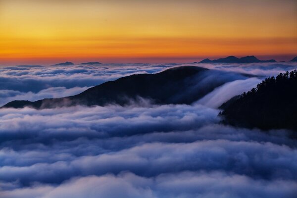 Dawn in the mountains above the clouds