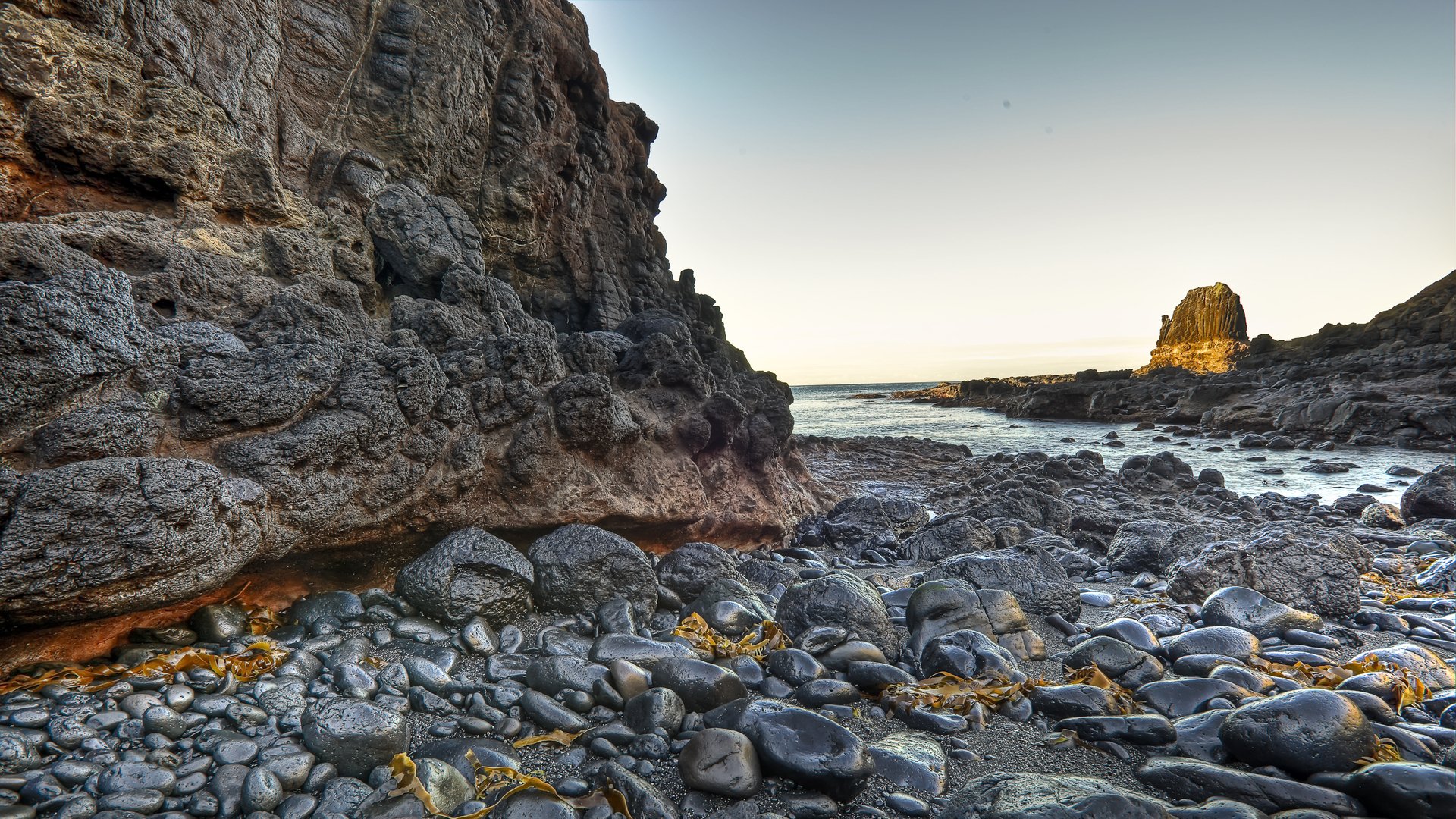 beach water rock stones sky light