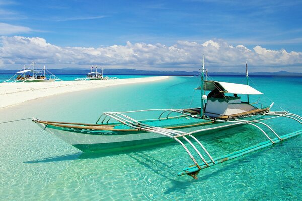 Canoe in clear water on the shore