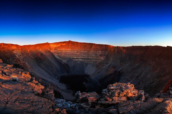 Sunset turns the volcano s crater purple