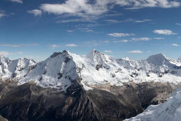 Mountain snow-capped hills against the sky