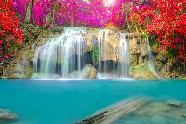 Waterfall among rocks and autumn trees