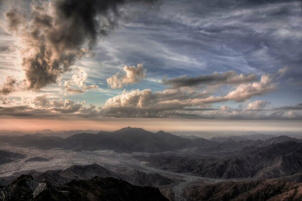 Watercolor sky. Clouds over the mountains