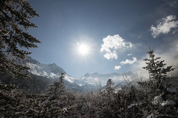 Image of a mountain against a background of snow and white clouds