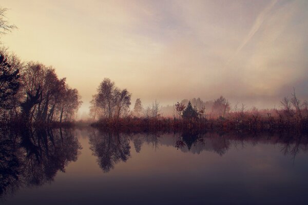 Magic lake in the morning in the fog