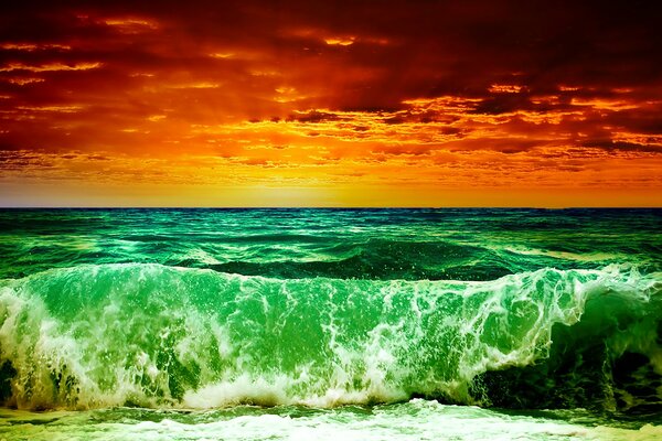 A sea wave at a burning sunset