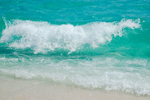 Sea foam on the snow-white shore of the beach