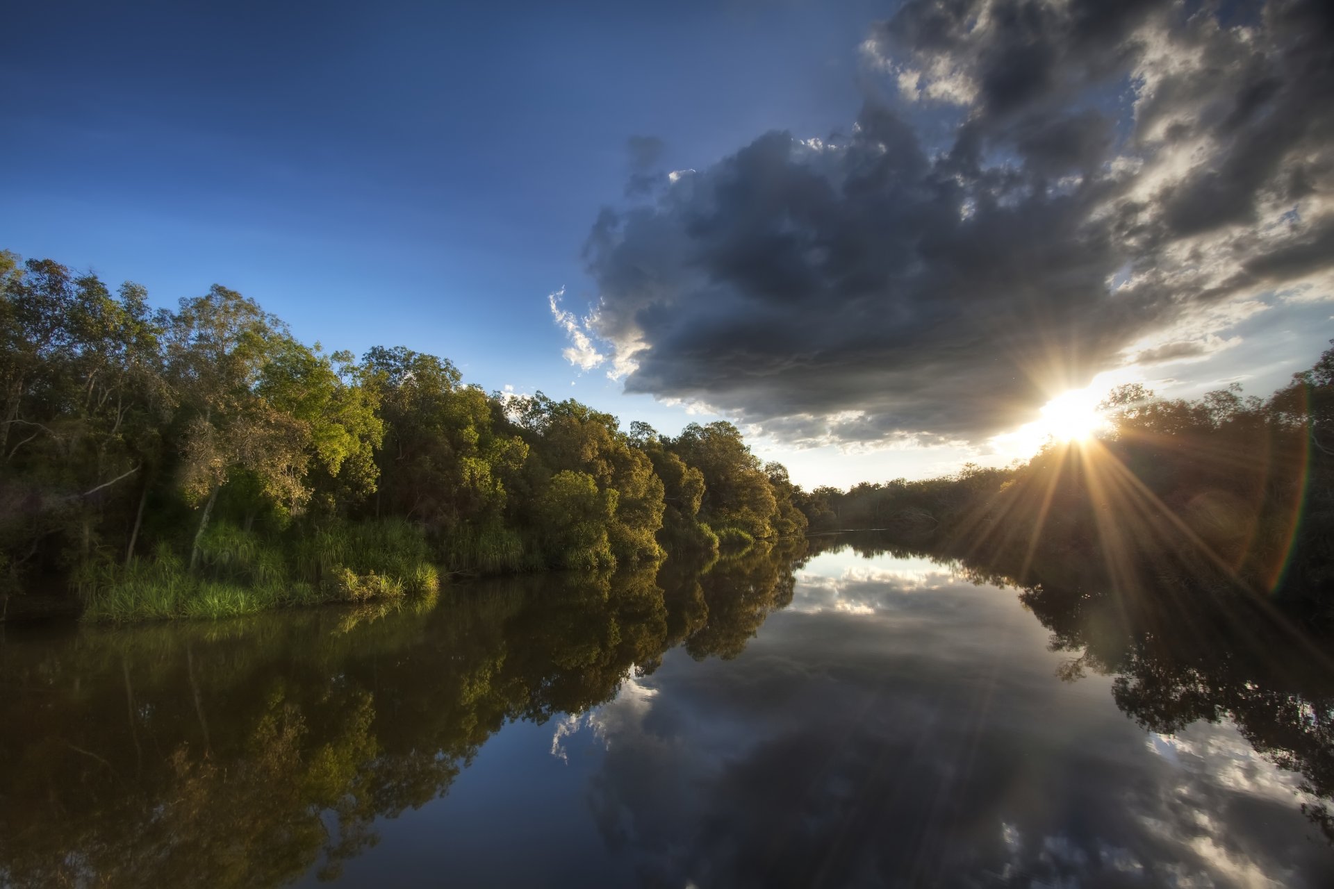 australia parco nazionale alberi foresta riva fiume mattina sole raggi cielo nuvole riflessione