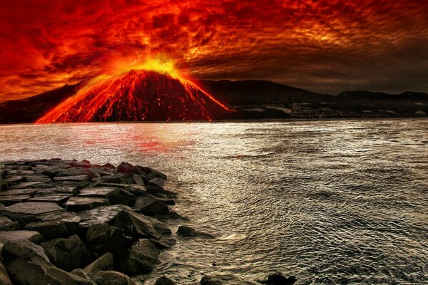 Erupción volcánica en el mar junto a las rocas