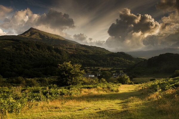 Valle de montaña con nubes volumétricas