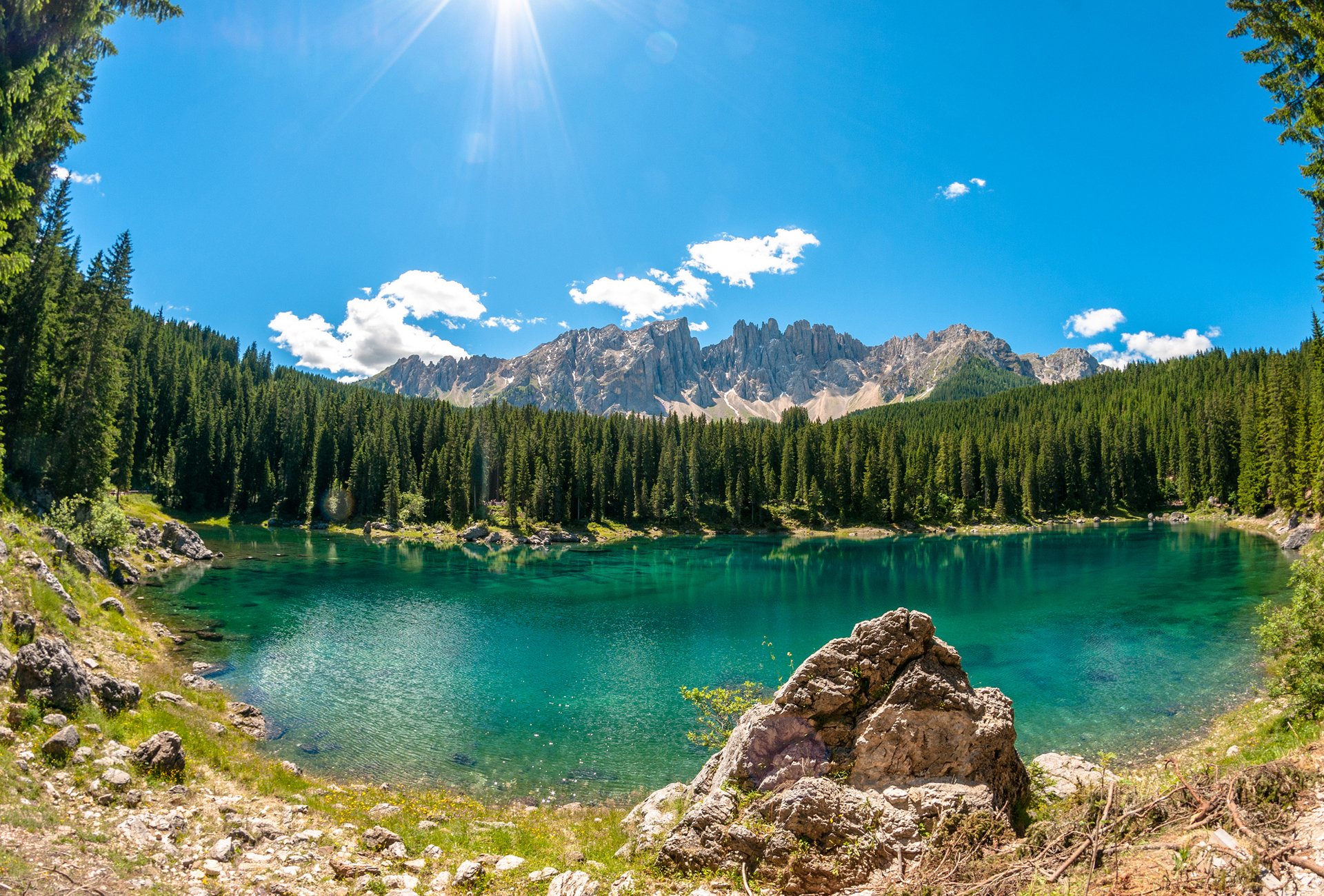 lago di carezza lake forest tree stones clouds solar