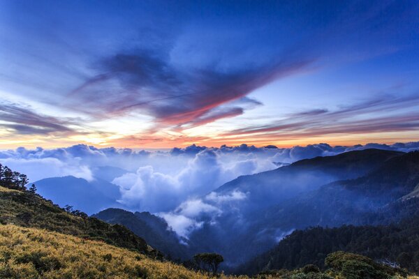 Clouds soar high above the mountains and hills