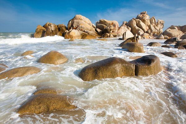 The waves of the sea break on the rocks on the shore