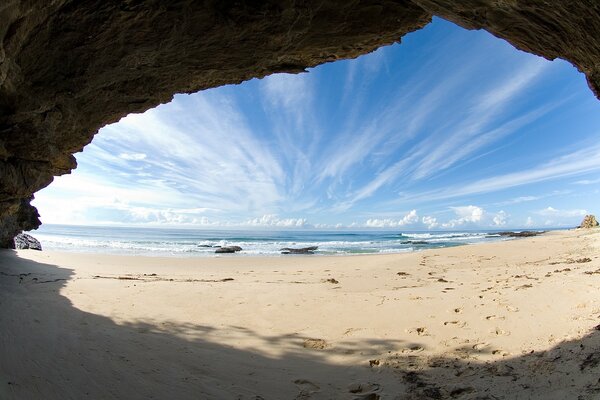 The view from the small cave to the calm sea and the stunning sky