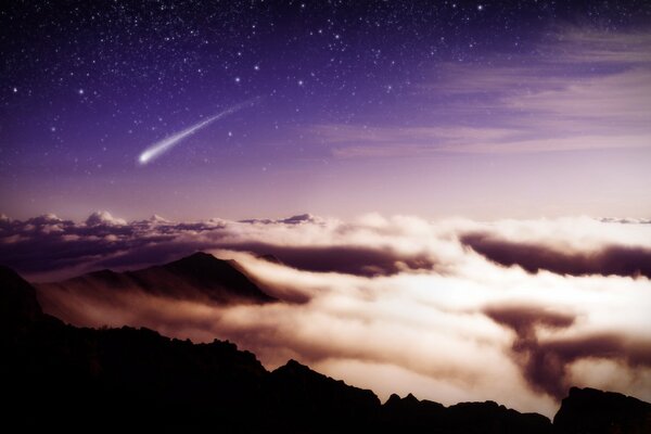 Meteor in the starry sky over the mountains