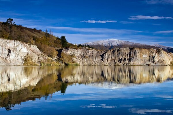 Bizarre rocks on the shore of the blue lake