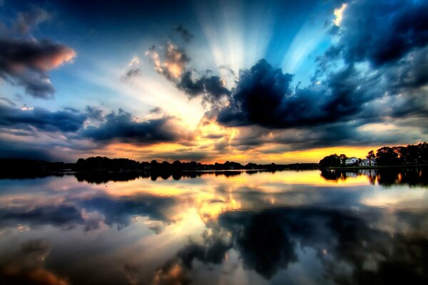 The cloudy sky is reflected in a beautiful lake