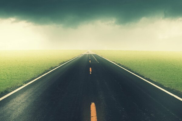 A marked road in the middle of endless fields